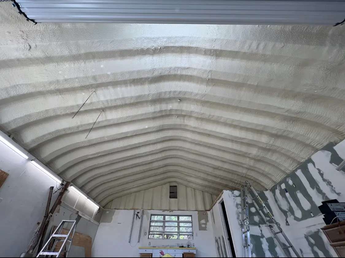 Spray polyurethane foam applied to the underside of a metal roof deck in Somerville